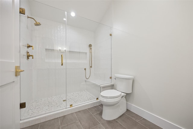 bathroom with toilet and an enclosed shower