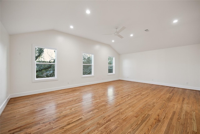 unfurnished room featuring light hardwood / wood-style flooring, vaulted ceiling, and ceiling fan