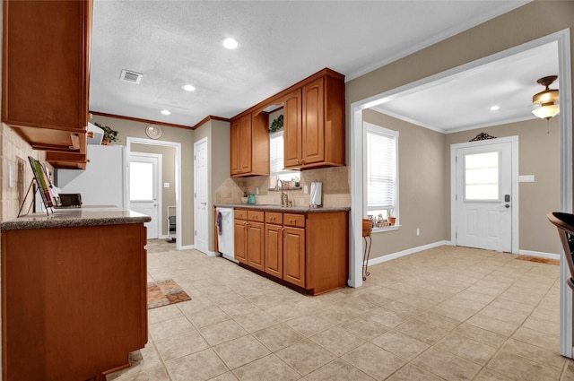 kitchen featuring crown molding, dishwasher, sink, and white fridge