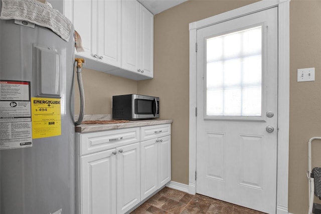 kitchen with white cabinetry and fridge