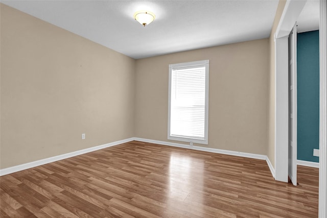 spare room with light hardwood / wood-style flooring