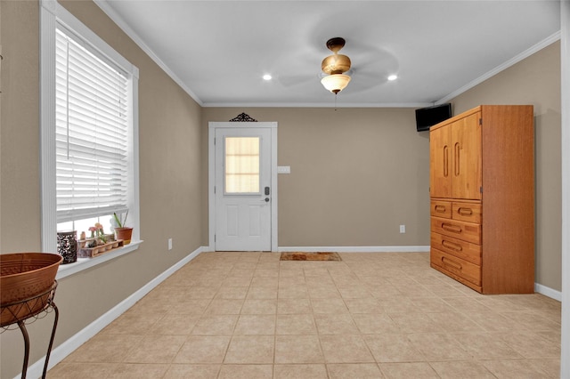 entryway featuring light tile patterned flooring and ornamental molding