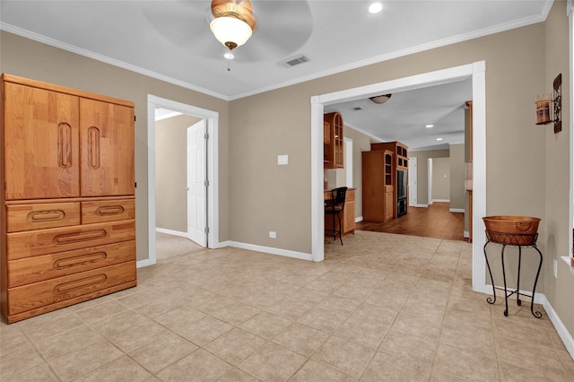 interior space featuring ornamental molding and ceiling fan