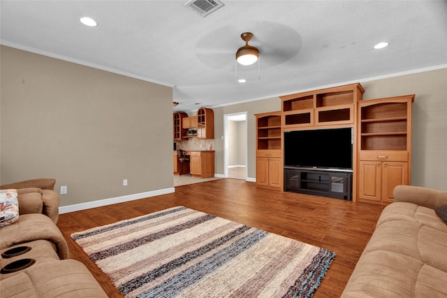 living room featuring crown molding, ceiling fan, and light wood-type flooring