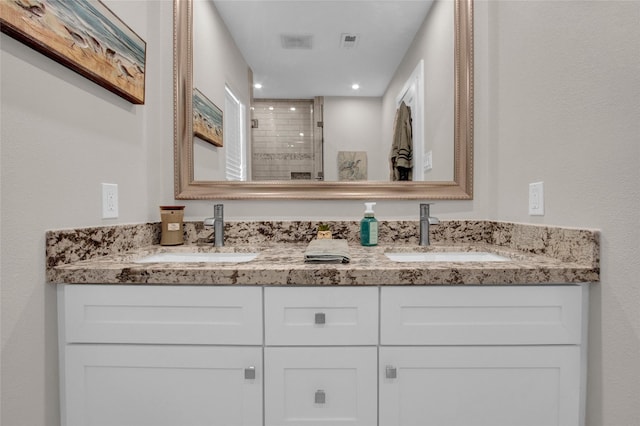 bathroom featuring vanity and a shower