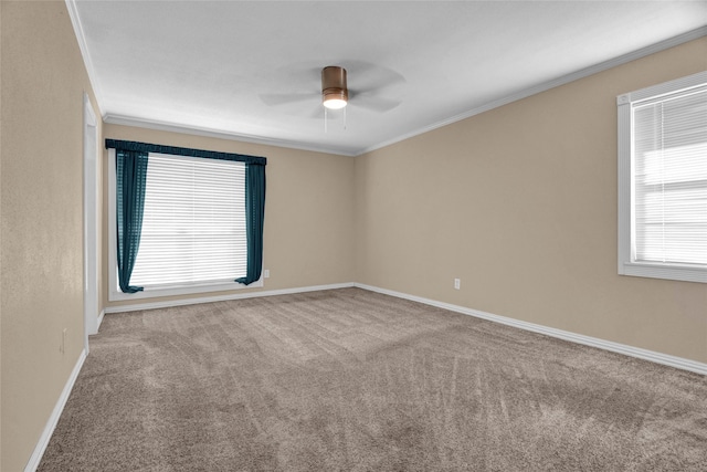 spare room with ornamental molding, carpet floors, and ceiling fan