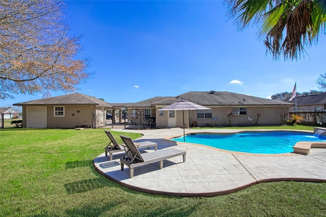 view of swimming pool with a yard and a patio area