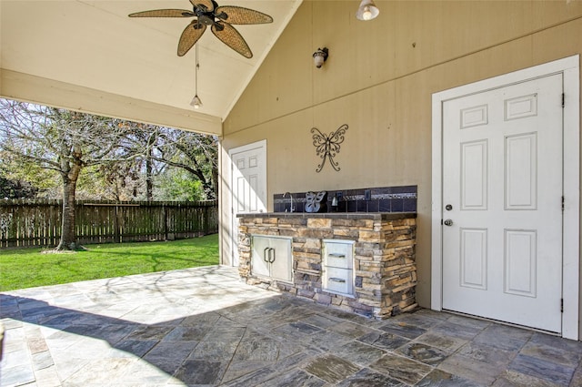 view of patio / terrace with an outdoor kitchen and ceiling fan