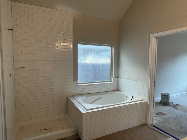 bathroom with vaulted ceiling and separate shower and tub