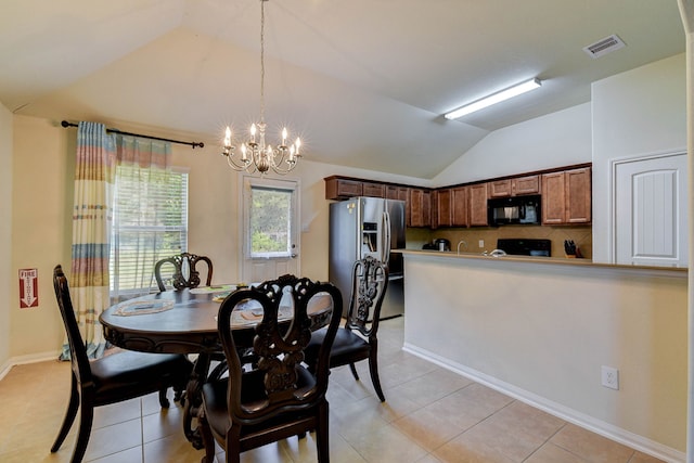 dining area featuring lofted ceiling, a notable chandelier, and light tile patterned flooring