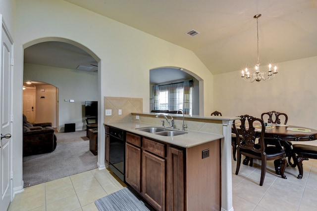 kitchen with vaulted ceiling, decorative light fixtures, dishwasher, sink, and light tile patterned floors