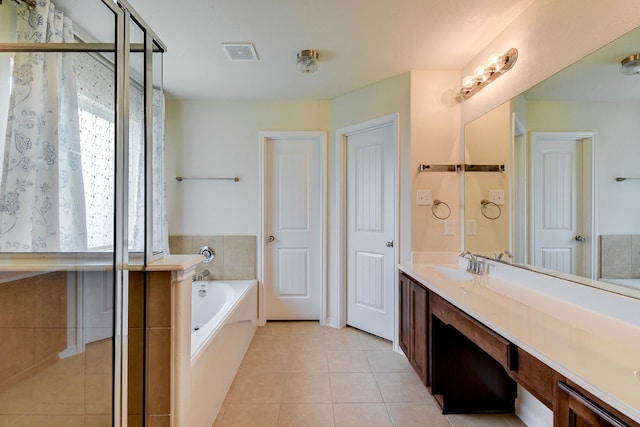 bathroom with vanity, shower with separate bathtub, and tile patterned flooring