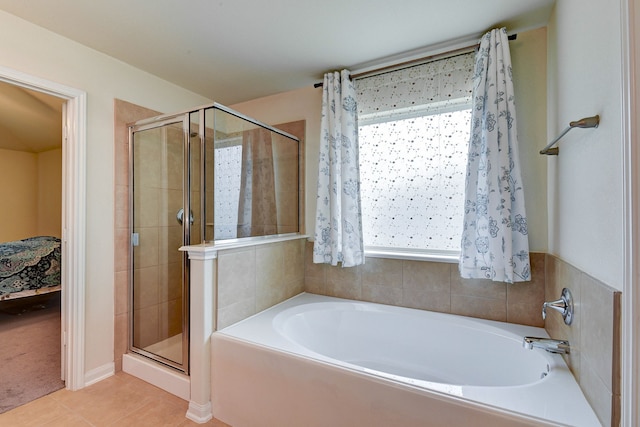 bathroom featuring tile patterned flooring and separate shower and tub