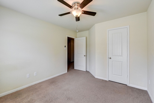 unfurnished bedroom featuring light colored carpet and ceiling fan