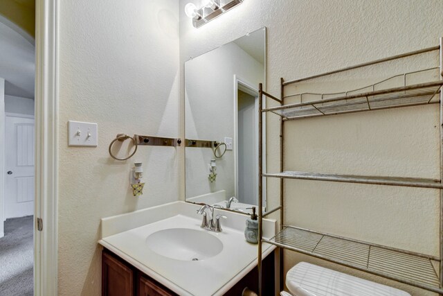 bathroom with vanity and toilet