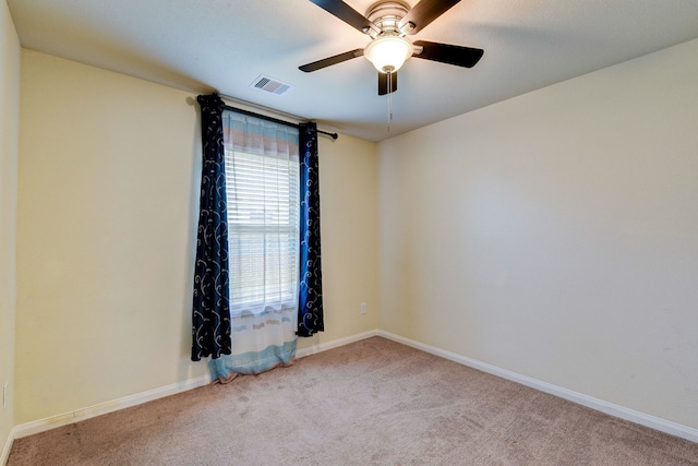 carpeted spare room featuring ceiling fan