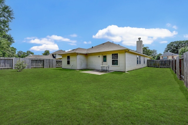 rear view of property with a patio and a lawn