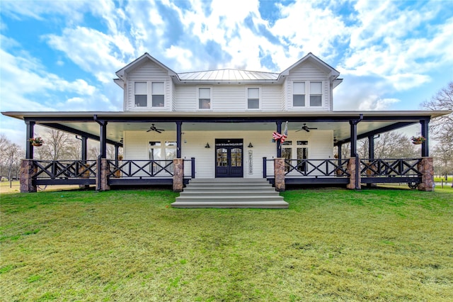 farmhouse with a front lawn, ceiling fan, and french doors