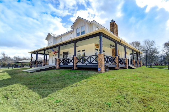 exterior space featuring a yard, covered porch, and ceiling fan