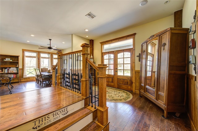 entrance foyer featuring a wealth of natural light, dark hardwood / wood-style floors, and french doors