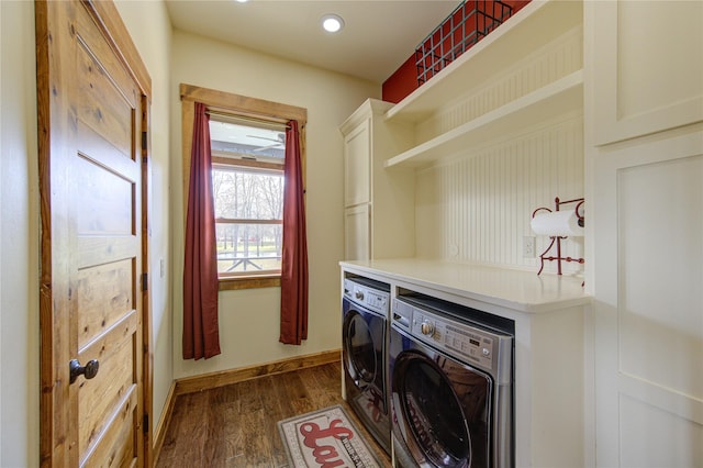 washroom with cabinets, separate washer and dryer, and dark hardwood / wood-style flooring