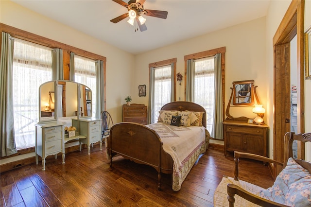 bedroom with dark hardwood / wood-style floors and ceiling fan