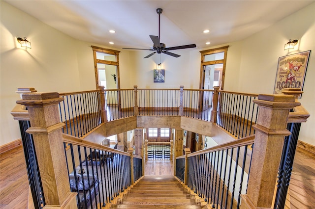 stairway featuring hardwood / wood-style floors and ceiling fan