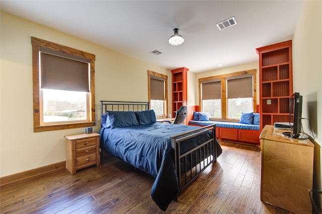 bedroom with dark wood-type flooring