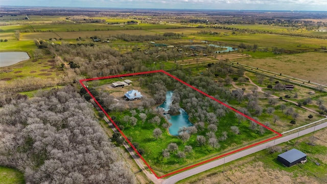 bird's eye view featuring a rural view and a water view