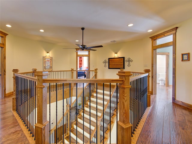 corridor with hardwood / wood-style flooring