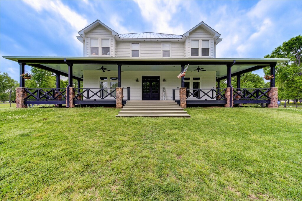 600 Chisolm Trl, Simonton, TX 77476 - country-style home featuring metal roof, ceiling fan, a front lawn, and french doors