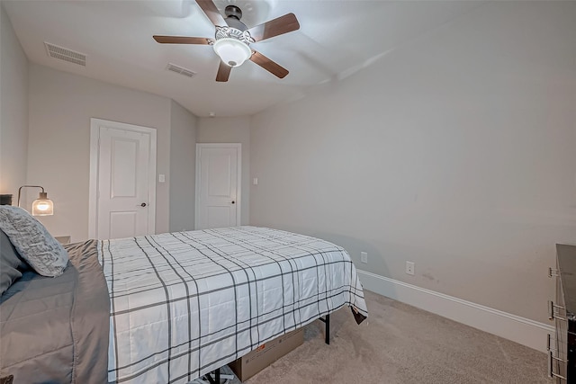 bedroom featuring a ceiling fan, visible vents, light carpet, and baseboards