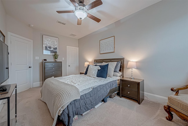 bedroom with baseboards, a ceiling fan, visible vents, and light colored carpet