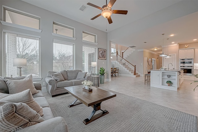 living room with light tile patterned floors, recessed lighting, visible vents, baseboards, and stairs