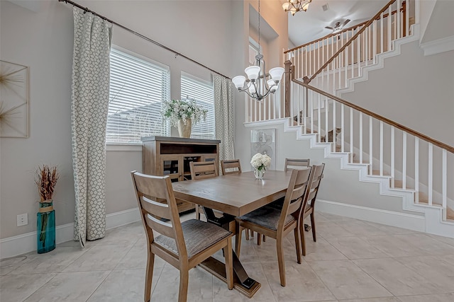 dining room with an inviting chandelier, stairs, baseboards, and light tile patterned flooring