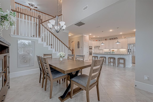 dining room with visible vents, stairway, a chandelier, and light tile patterned flooring