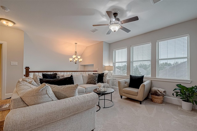 living room featuring light carpet, baseboards, visible vents, and lofted ceiling