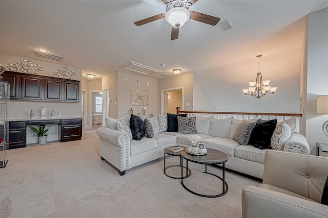 living room featuring attic access, visible vents, and light colored carpet