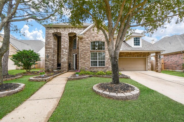 view of front of home featuring a garage and a front yard