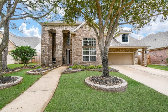 traditional-style home with a front yard, an attached garage, brick siding, and driveway