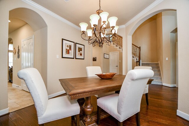 dining area featuring dark wood-type flooring and ornamental molding