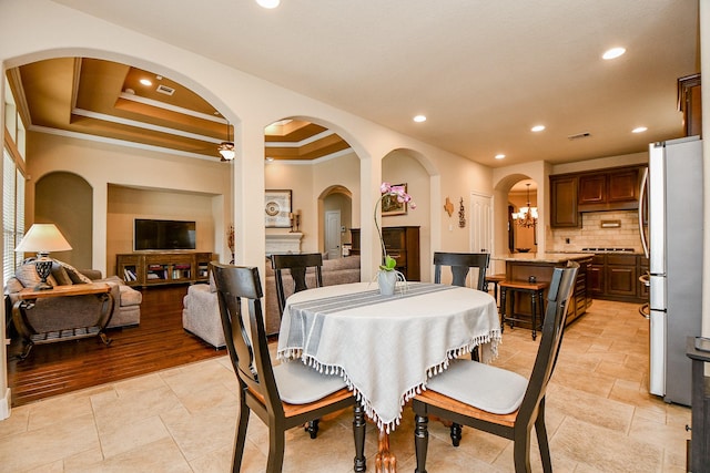 dining space featuring recessed lighting and a tray ceiling