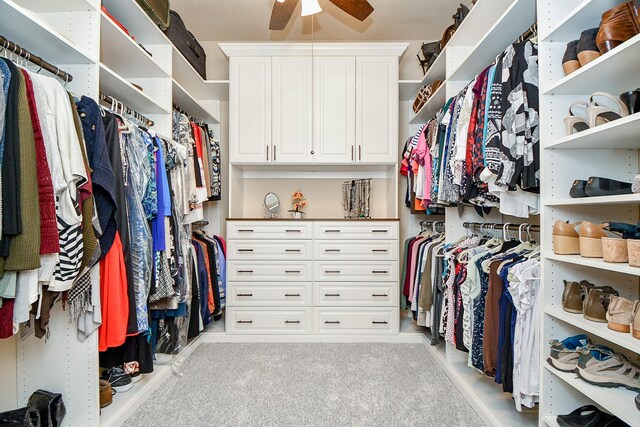 spacious closet featuring light carpet and ceiling fan