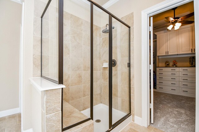 bathroom featuring ornamental molding, ceiling fan, and walk in shower