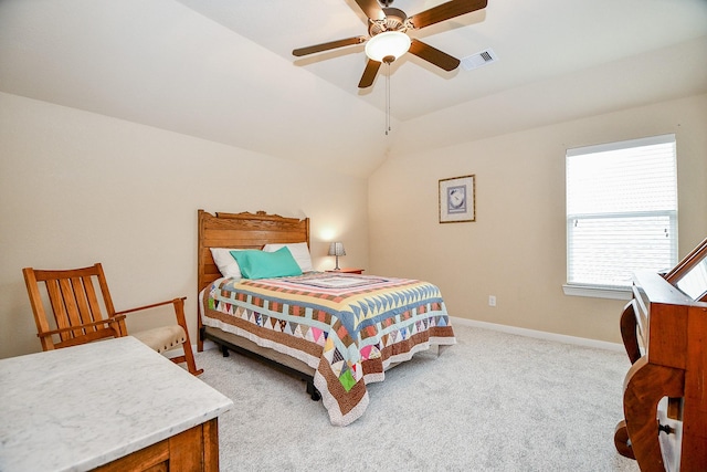 carpeted bedroom with visible vents, lofted ceiling, baseboards, and ceiling fan