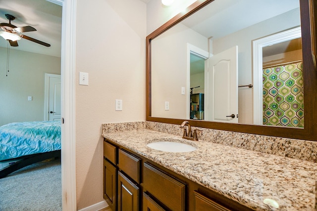 bathroom featuring vanity, a ceiling fan, and baseboards