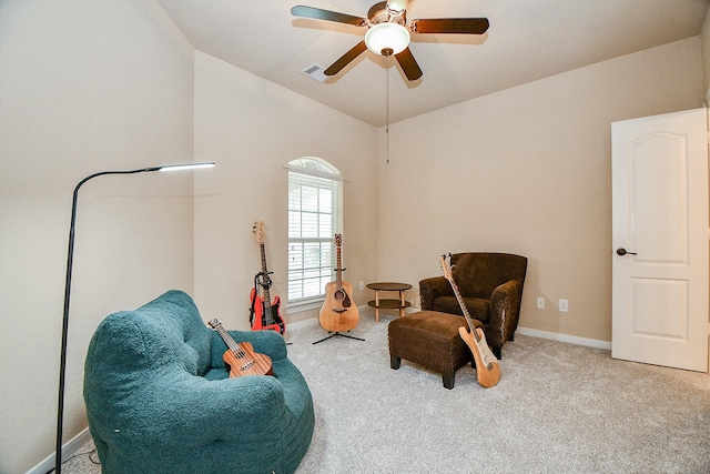 living area with visible vents, baseboards, ceiling fan, and carpet flooring