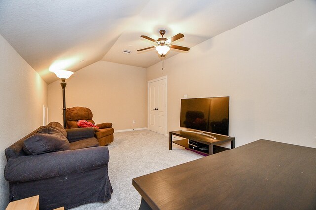 carpeted living room featuring ceiling fan and lofted ceiling