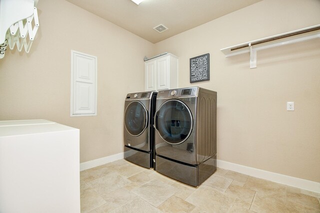 laundry area with cabinets and washer and dryer