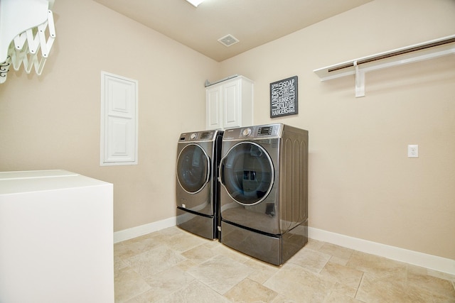 laundry room featuring cabinet space, separate washer and dryer, and baseboards